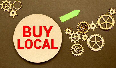 Advice to Buy Local printed on a brown paper price tag as a means of supporting local suppliers and...