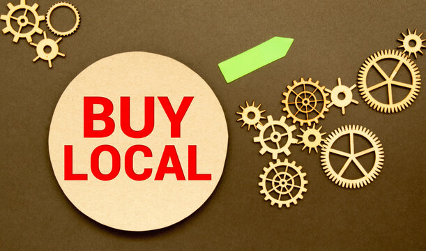 Advice to Buy Local printed on a brown paper price tag as a means of supporting local suppliers and producers