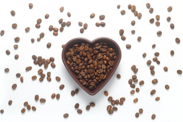Roasted coffee beans in heart shaped bowl on white background. Love coffee concept. Top view flat lay with copy space