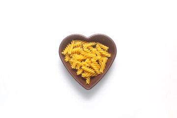 pasta isolated on white background. pasta is laid out in the shape of a heart. durum flour products