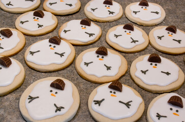 Festive cookies for Christmas. Melting snowman sugar cookies on table.