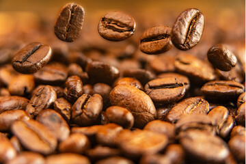 Arabica coffee beans, roasted aromatic fruits of the coffee tree. Grains in motion, macro photography.