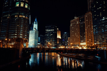 Fototapeta na wymiar wide shot of downtown chicago river at night with city skyline in background