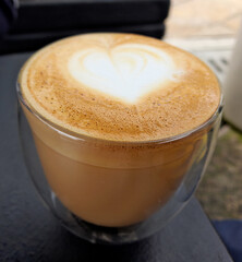 Cup of coffee latte with heart.