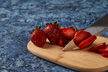 knife cutting strawberry on wooden board © gabriel