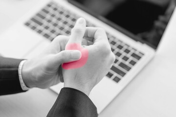 business man having problem trigger finger in office.Hand trigger finger lock when work hard...