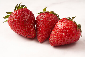close up three strawberry on white marble white background isolated