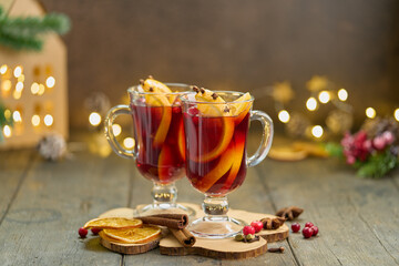 Alcohol red mulled wine with cardamom, cinnamon, clove, orange, anise, cranberry. Winter christmas...