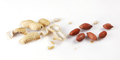 Peanut nuts are separated from shells near, isolated on white background close-up