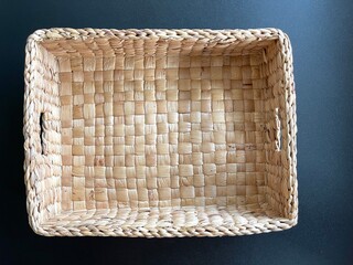 Handmade basket made from dried water hyacinth, woven basket for home use and decoration, weaved basket on black background 