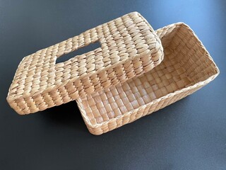 Handmade woven napkin paper box made from dried water hyacinth, woven tissue box for home use and decoration, weaved tissue paper box on black background 
