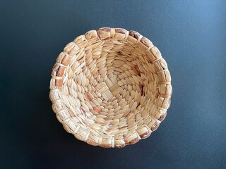 Handmade round shape basket made from dried water hyacinth, woven basket for home use and decoration, weaved basket on black background 