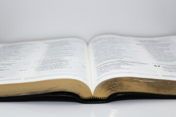 bible opened on a table white background