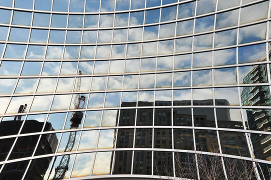 tower crane reflected on concave window
