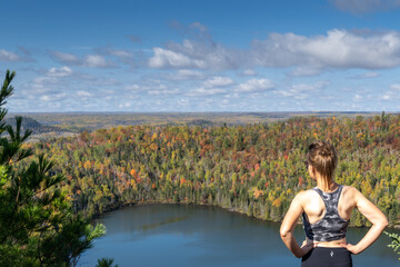 Naklejka na ściany i meble Above Bean and Bear Lakes in Minnesota, during the fall - woman posing