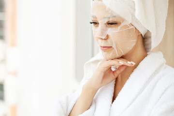 Woman with cotton face mask in beauty salon