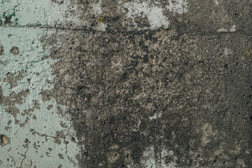 The texture of the wall of the sea pier. Affected by high humidity concrete wall. Fungus and mold on the surface of the concrete.