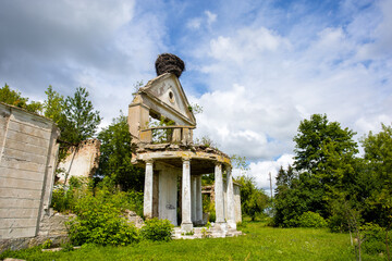 Old ruined building with columns surrounded by a green trees. High quality photo