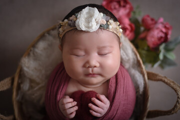 Cute adorable little small newborn baby girl posing smiling sleeping