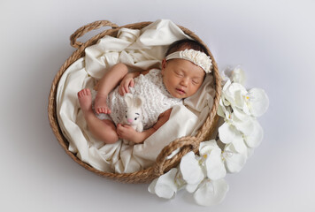 Fototapeta na wymiar Cute adorable little small newborn baby girl posing smiling sleeping