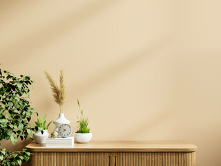 Interior cream color wall mockup with green plant.