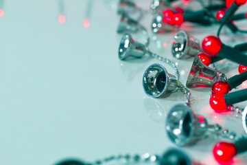 red lights and christmas bells on a cyan background, copy space