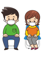 パイプ椅子に座る若者　マスク着用