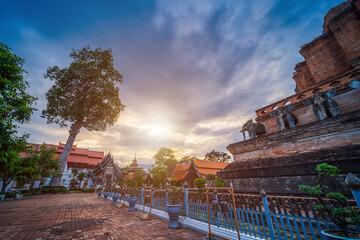 Fototapeta na wymiar Wat Chedi Luang is a Buddhist temple in the historic centre and is a Buddhist temple is a major tourist attraction in Chiang Mai,Thailand.at twilight time blue sky clouds sunset background.