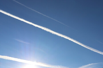 Fototapeta na wymiar Contrails from an airplane in the blue sky. The concept of travel