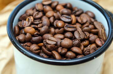 coffee beans in an enamel mug