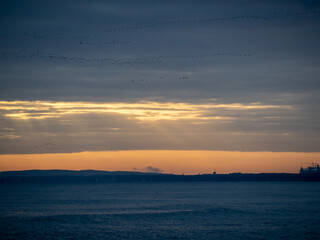 Picturesque seascape during sunset, Golden shining reflection of sunlight on the sea.