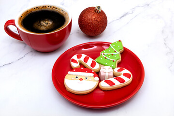 Sugar coated cookies on a bright red plate.  Christmas cookies and coffee.