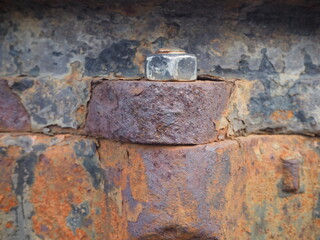 The message on the stainless steel plate is fastened with screws on the iron that is outdoors, weathered to rust and decay.