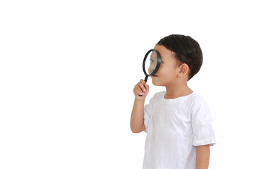 Asian little baby boy looking through a magnifying glass to beside isolated on white background with copy space