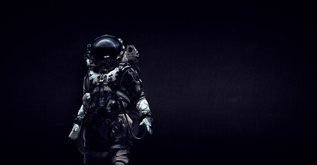 Fototapeta premium Astronaut in suit against black background. Space technology concept . Mixed media