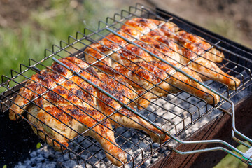 Chicken grilled on a charcoal barbeque brazier