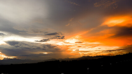 Mountain horizon and dramatic twilight black sky and cloud sunset background.
