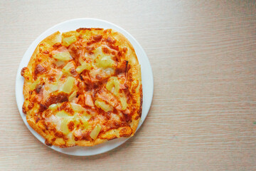 Close up of Pizza with pineapple,  mozzarella cheese, ham, bacon, pizza sauce. Sliced Hawaiian pizza texture, 