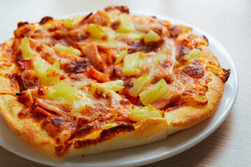 Close up of Pizza with pineapple,  mozzarella cheese, ham, bacon, pizza sauce. Sliced Hawaiian pizza texture, 