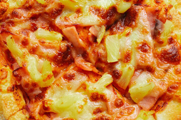 Close up of Pizza with pineapple,  mozzarella cheese, ham, bacon, pizza sauce. Sliced Hawaiian pizza texture, 