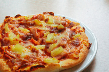 Close up of Pizza with pineapple,  mozzarella cheese, ham, bacon, pizza sauce. Sliced Hawaiian pizza texture, 