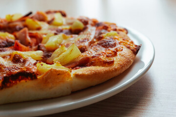 Close up of Pizza with pineapple,  mozzarella cheese, ham, bacon, pizza sauce. Sliced Hawaiian pizza texture, 