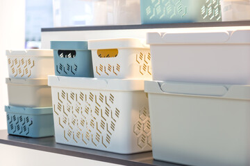 Plastic containers on a shelf on a rack for organizing home space, order and interior, sale of household goods