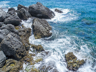 waves hitting rocks in the summer sun in Budva, Montenegro