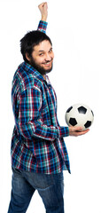 a man stands with his back to us, turned around and looked at the camera, holding a soccer ball.
