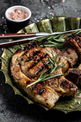 grilled pork chop steak on metal plate. Keto Paleo diet menu. Top view