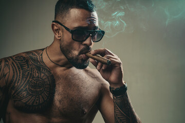 Smoking brutal gang men. Fashion brutal latin guy with sexy naked torso.
