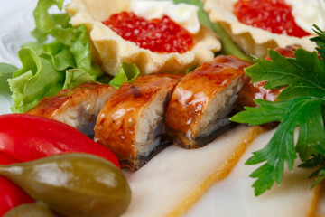 Image of plate with fish snack on white background