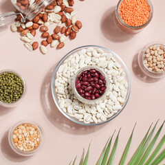 Vegan protein source. Beans, peas, chickpeas, lentils, mung bean, peanut in bowl on beige background.