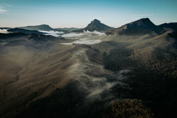 Aerial view of Mount Lindesay peak at sunrise with morning fog